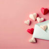 cartão com corações de papel em fundo rosa