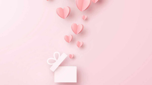 Corações saindo de uma caixa de presente. Elementos feitos de papel em um fundo rosa. Símbolos vetoriais de amor em forma de coração.
