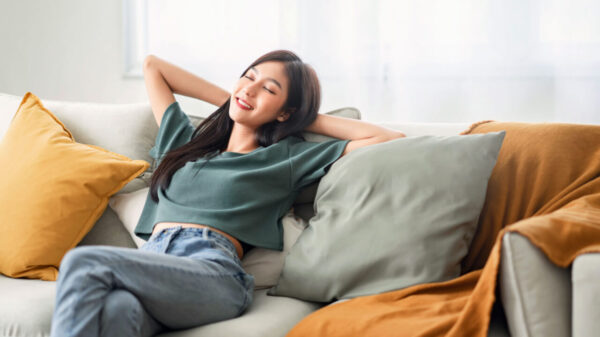 mulher sentada em um sofá em posição de estar relaxada