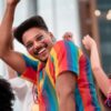 homem com roupas coloridas comemorando o carnaval de rua